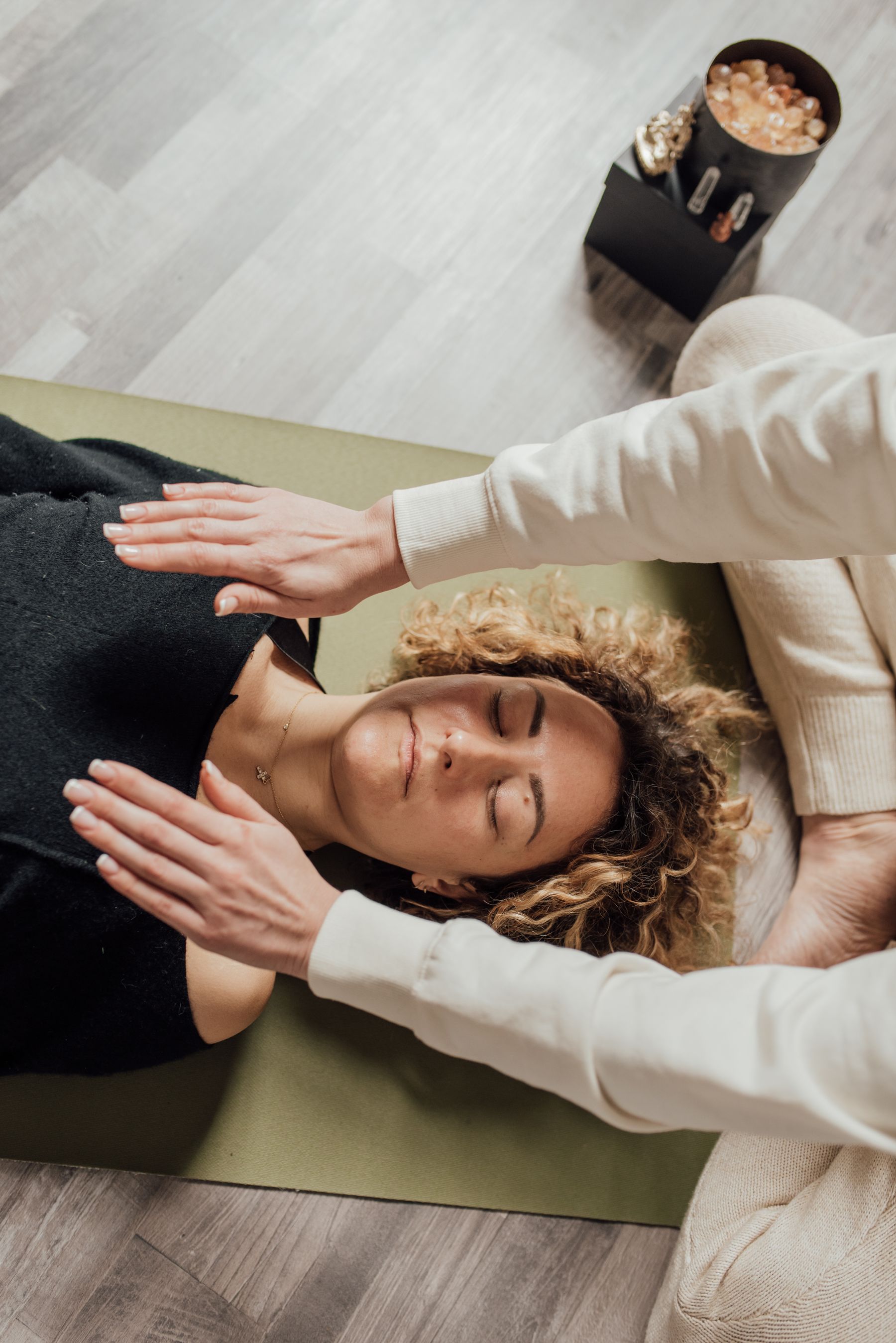 Reiki energy work with hands held gently above a resting body